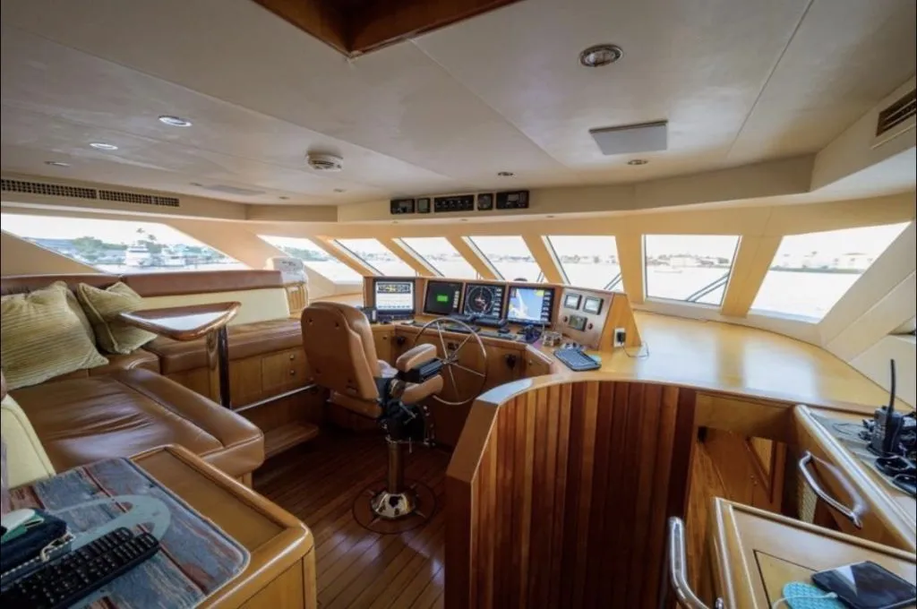 The wheelhouse of a superyacht, helm and instruments in warm timber
