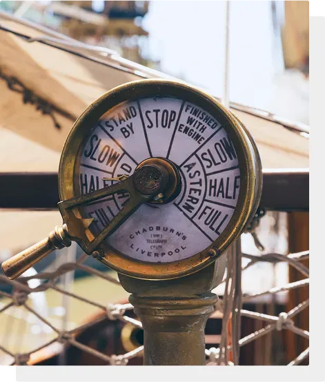 A brass ship’s engine-order telegraph reading Stand By, Slow, Half and Full